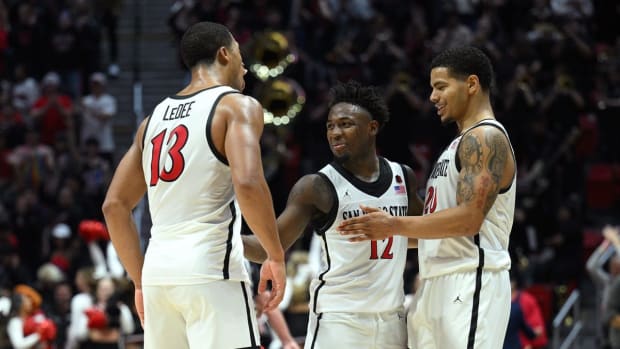 Nov 11, 2022; San Diego, California, USA; San Diego State Aztecs forward Jaedon LeDee (13) celebrates with guard Darrion Trammell (12) and guard Matt Bradley (20) after defeating the Brigham Young Cougars at Viejas Arena. Mandatory Credit: Orlando Ramirez-USA TODAY Sports
